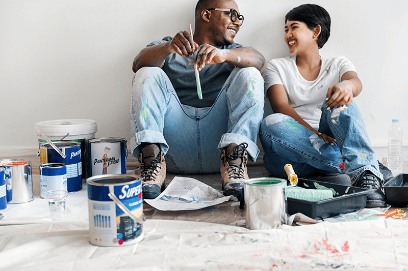 happy couple painting their house